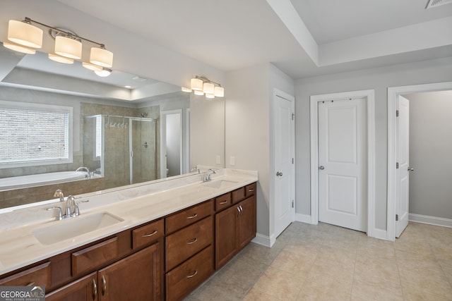 bathroom with vanity, independent shower and bath, tile patterned flooring, and a raised ceiling