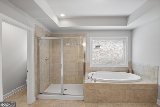 bathroom with tile patterned floors, toilet, and separate shower and tub