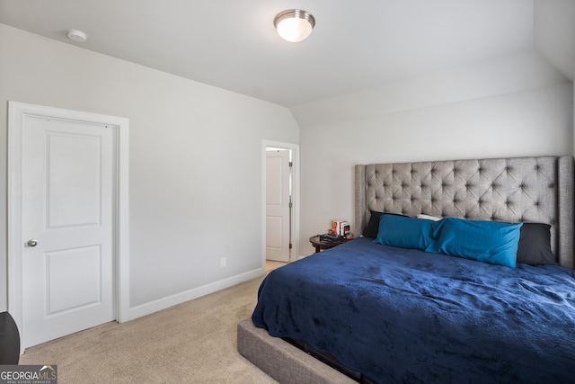 carpeted bedroom featuring lofted ceiling