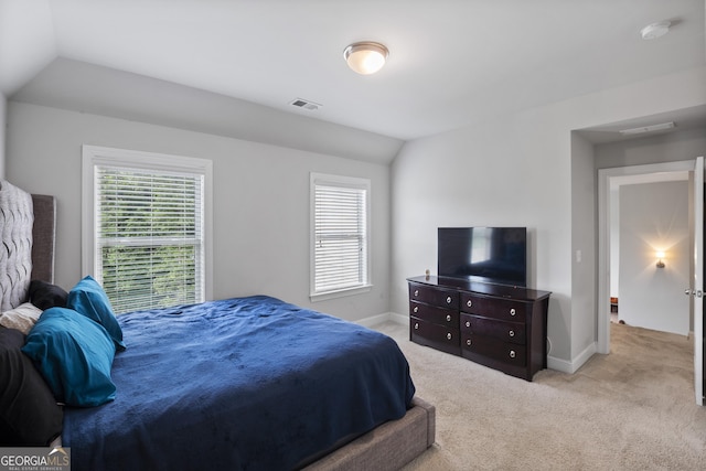 carpeted bedroom with lofted ceiling