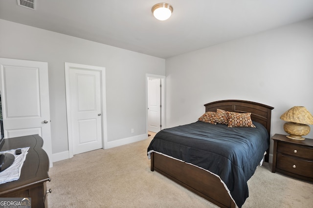 bedroom featuring light carpet