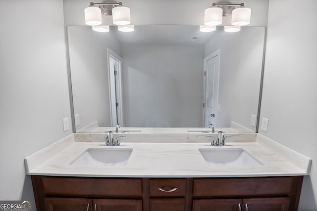 bathroom with vanity and a notable chandelier