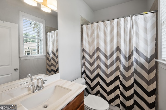 bathroom featuring vanity, toilet, and a shower with shower curtain