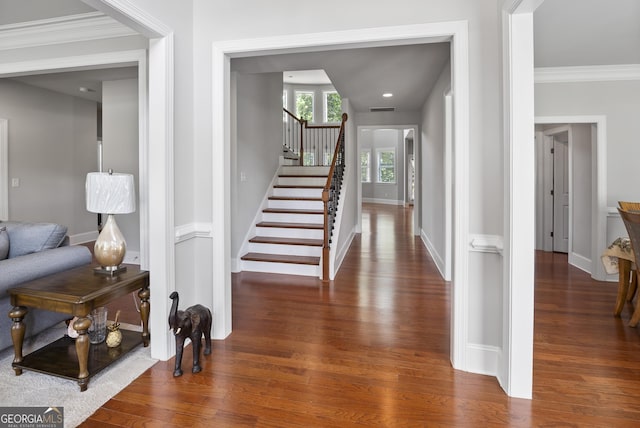 entryway featuring crown molding and dark hardwood / wood-style floors