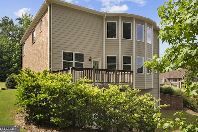 back of property with a wooden deck