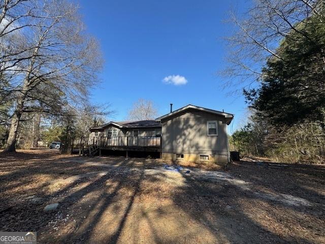 view of home's exterior featuring a wooden deck