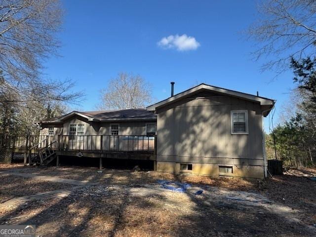 rear view of house with a wooden deck