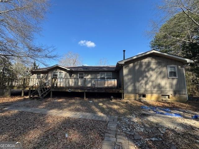 rear view of house with a wooden deck