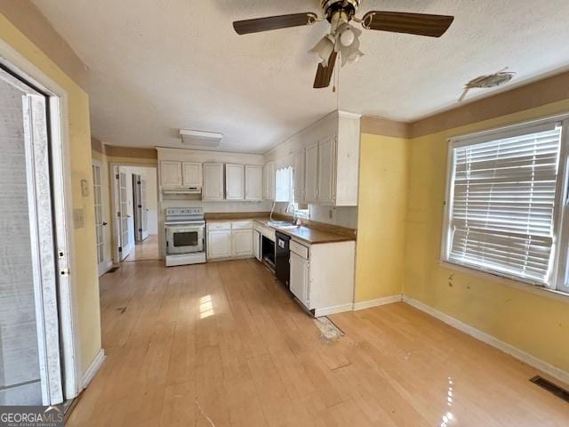 kitchen featuring range, white cabinets, a textured ceiling, and light hardwood / wood-style flooring