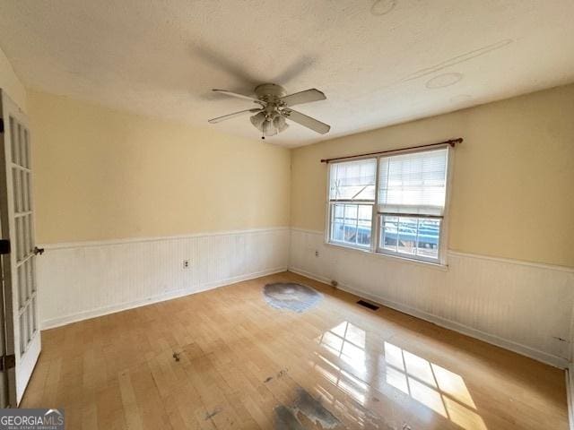 unfurnished room featuring ceiling fan and light wood-type flooring