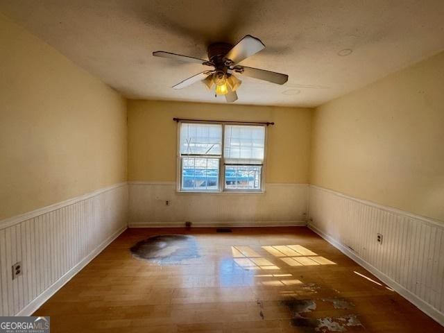 spare room with hardwood / wood-style flooring and ceiling fan