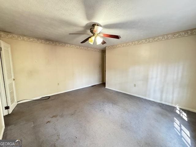 spare room with ceiling fan and a textured ceiling