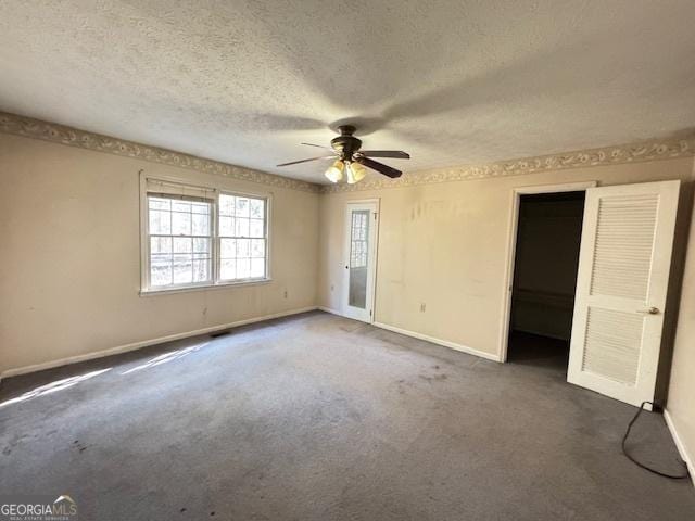 spare room featuring ceiling fan, a textured ceiling, and carpet flooring