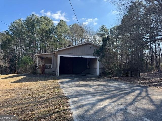 view of side of property featuring a porch and a garage