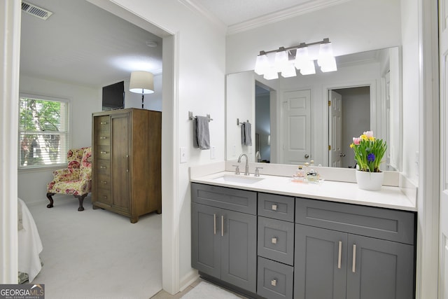 bathroom with vanity and ornamental molding