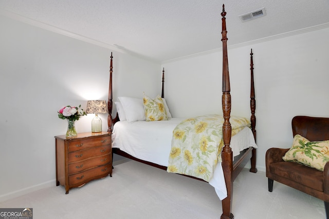 bedroom featuring light colored carpet, ornamental molding, and a textured ceiling