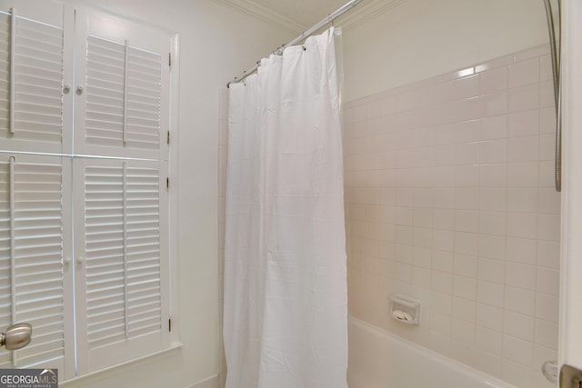 bathroom featuring crown molding and shower / tub combo