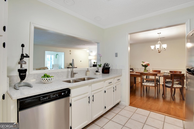 kitchen with white cabinets, sink, stainless steel dishwasher, light tile patterned floors, and a notable chandelier