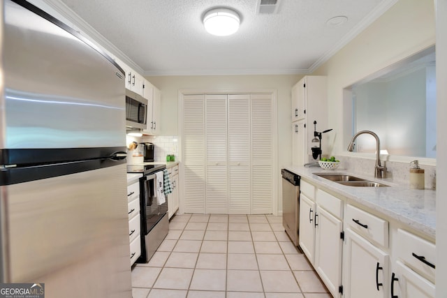 kitchen with white cabinets, appliances with stainless steel finishes, and sink