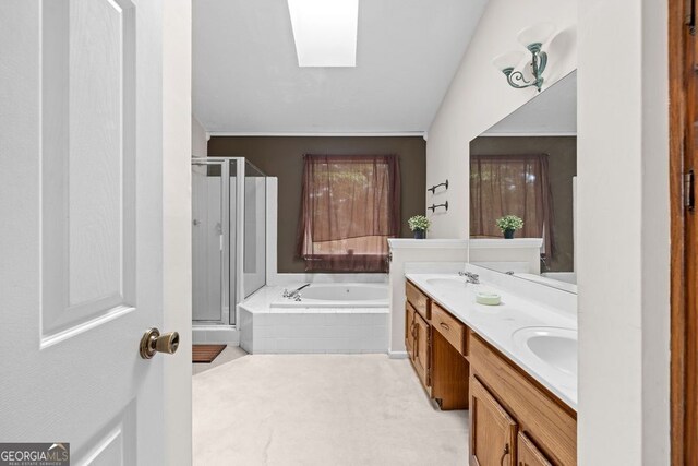 bathroom with a skylight, separate shower and tub, ornamental molding, and vanity