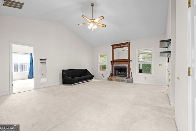 unfurnished living room featuring high vaulted ceiling, carpet floors, ceiling fan, and a tile fireplace