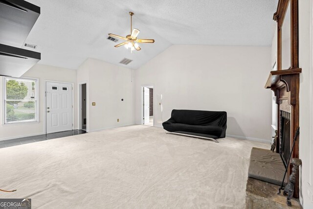 sitting room featuring a fireplace, carpet flooring, ceiling fan, high vaulted ceiling, and a textured ceiling