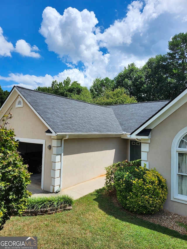 view of side of property with a yard