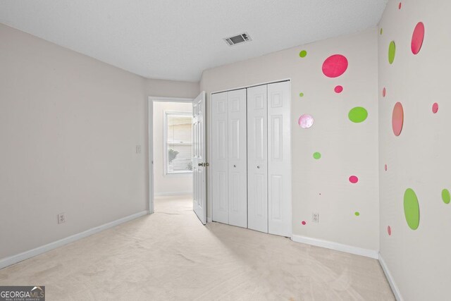 unfurnished bedroom featuring light colored carpet