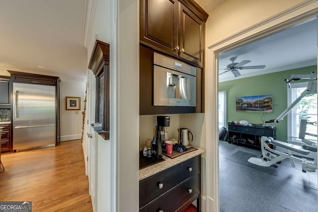 hall with crown molding and light hardwood / wood-style flooring