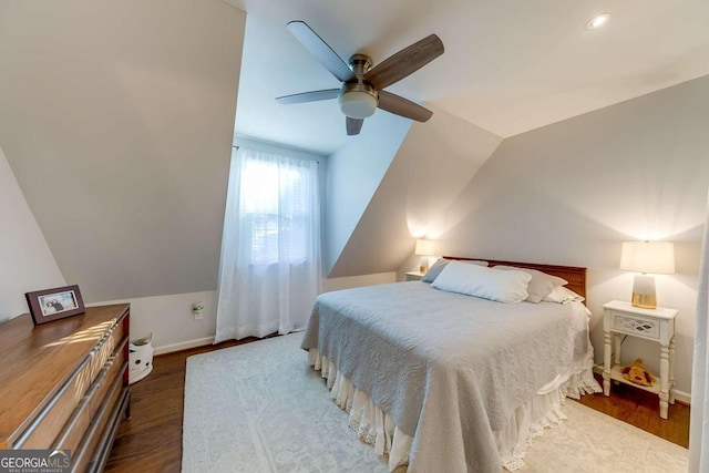 bedroom featuring lofted ceiling, dark hardwood / wood-style flooring, and ceiling fan