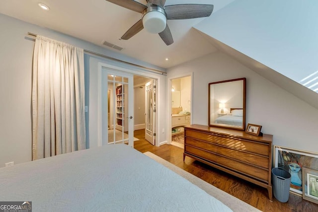 bedroom featuring wood-type flooring, lofted ceiling, ceiling fan, and ensuite bath