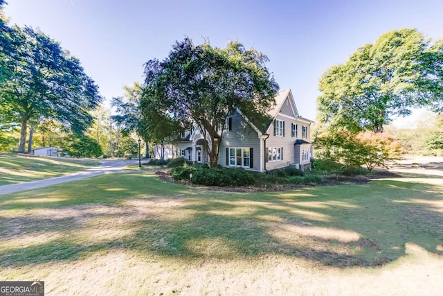 view of property exterior with a yard