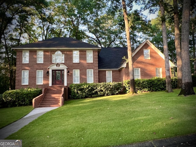 colonial home with a front lawn