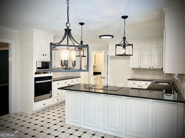 kitchen featuring decorative light fixtures, white cabinets, black appliances, and crown molding