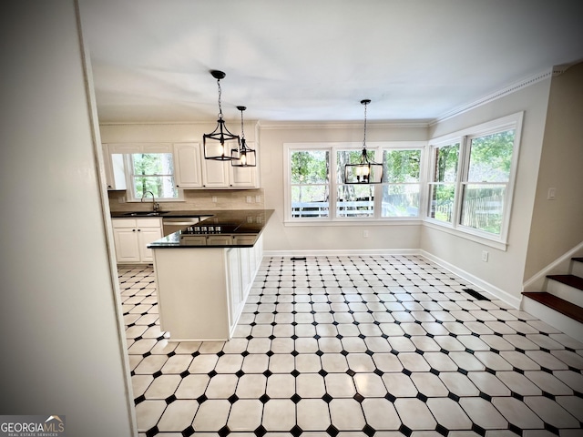 kitchen with sink, hanging light fixtures, white cabinets, and kitchen peninsula