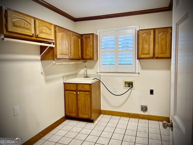 laundry room featuring electric dryer hookup, sink, hookup for a washing machine, light tile patterned flooring, and ornamental molding