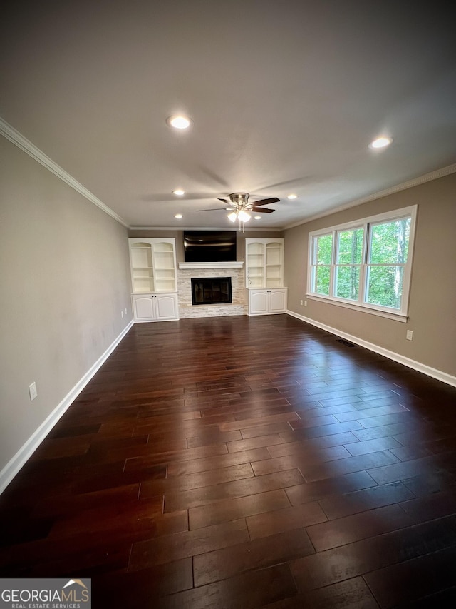 unfurnished living room featuring ceiling fan, dark wood-type flooring, and ornamental molding