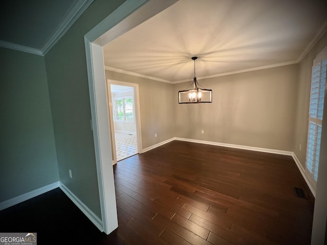 unfurnished dining area with crown molding, dark hardwood / wood-style floors, and a notable chandelier