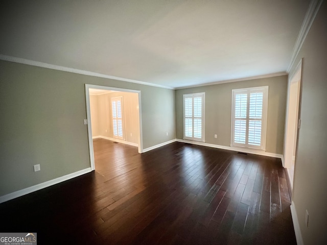 empty room with dark hardwood / wood-style floors and ornamental molding