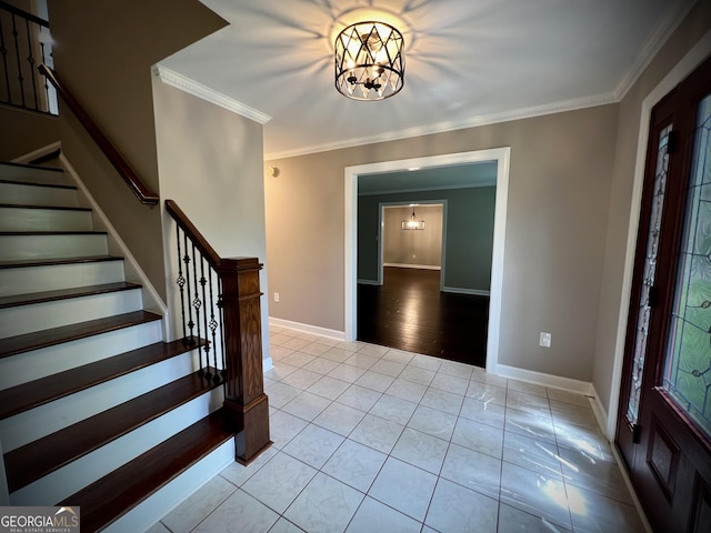 entryway featuring a notable chandelier, crown molding, and light tile patterned floors