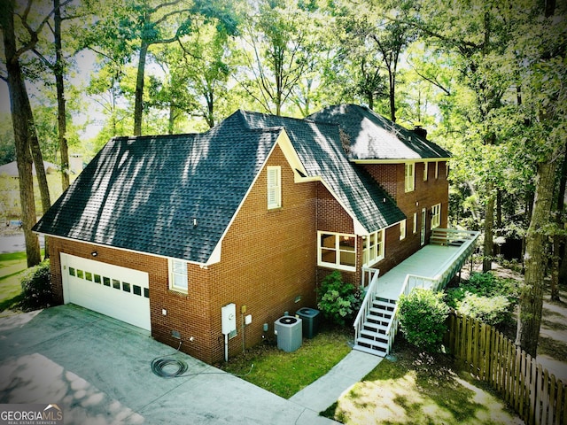 view of front facade with a garage and central AC unit