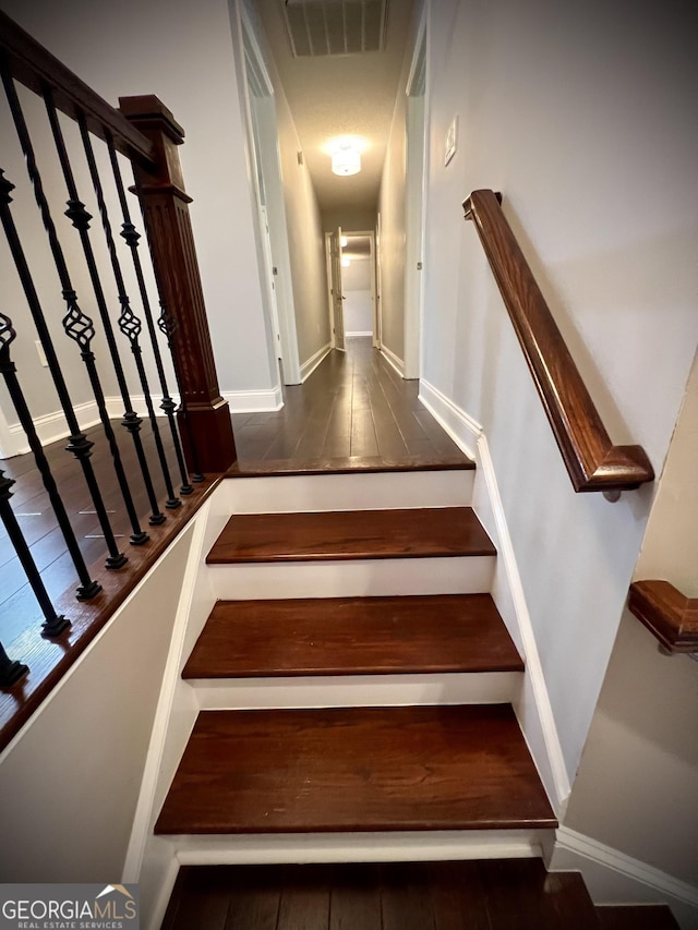 stairway with tile patterned flooring