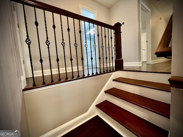 stairway with hardwood / wood-style floors