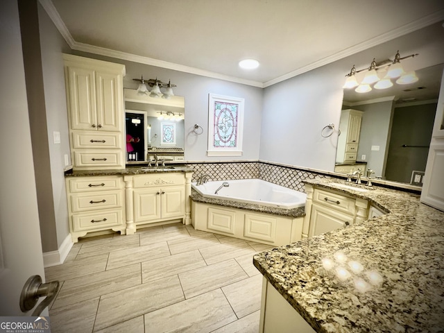 bathroom with a bathing tub, vanity, and ornamental molding