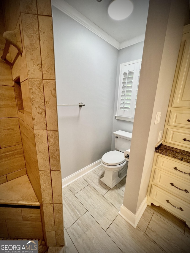 bathroom featuring toilet and ornamental molding