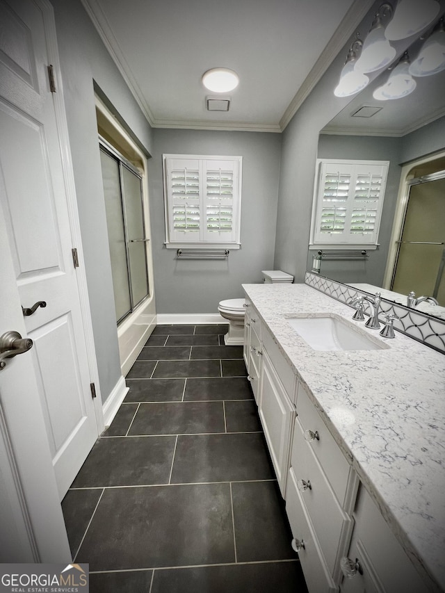 full bathroom featuring enclosed tub / shower combo, tile patterned floors, vanity, toilet, and ornamental molding