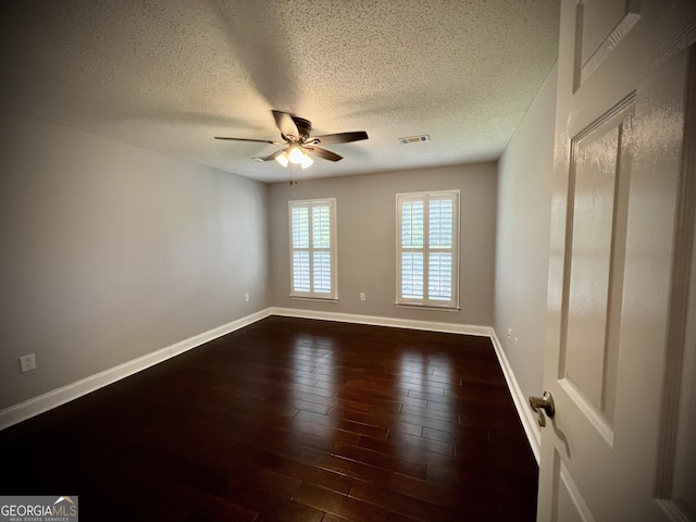 spare room featuring a textured ceiling, ceiling fan, and dark hardwood / wood-style flooring