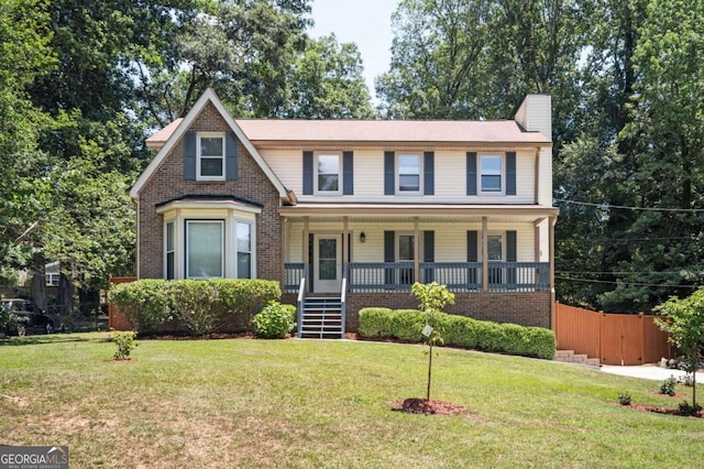 view of front of property featuring a front lawn and a porch