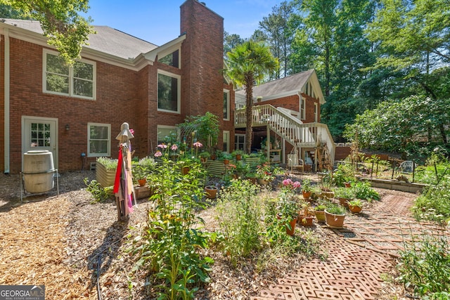 rear view of house featuring a wooden deck