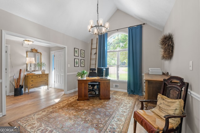 sitting room featuring vaulted ceiling, a notable chandelier, and light hardwood / wood-style floors